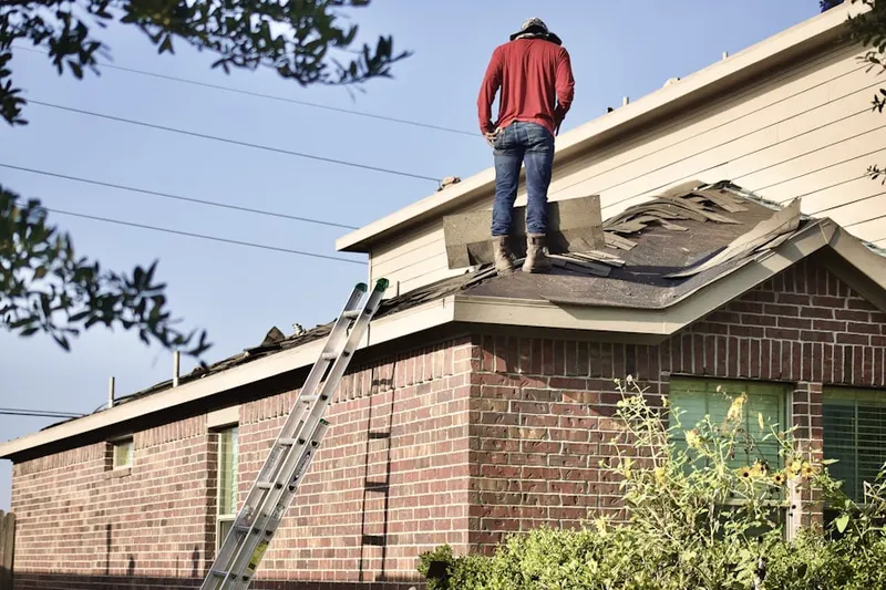 Professional roofer working on a residential roof in Ridgedale Park